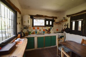 Cuina amb finestra, forlla i armaris verds.