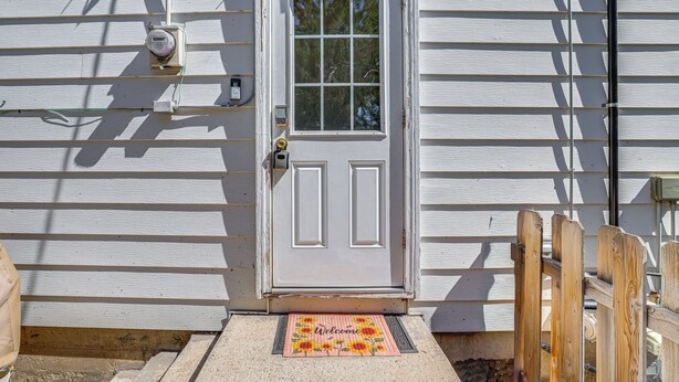 A white door with a window, a welcome mat, and a wooden fence. - Walk to Parks & Dining! Meridian Home w/ Patio (Meridian)