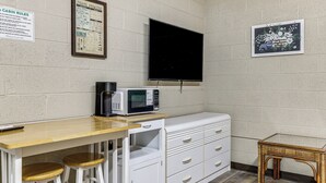A kitchenette with a microwave, bar stools, a small table, and a cabinet. - Studio w/ Greers Ferry Lake Access & Resort Perks! (Clinton)