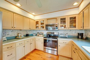 A kitchen with wooden cabinets, a stainless steel oven, a microwave, and a toaster. - Stunning Lakefront Camps, Escape/ Explore Together (Lake George)