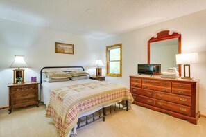 A bedroom with a bed, dresser, and a large mirror. - Stunning Lakefront Camps, Escape/ Explore Together (Lake George)