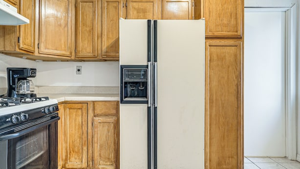A kitchen with wooden cabinets, a stainless steel refrigerator, a stove, and a microwave. - Great for Couples & Duos: Suite Outside El Paso (El Paso)
