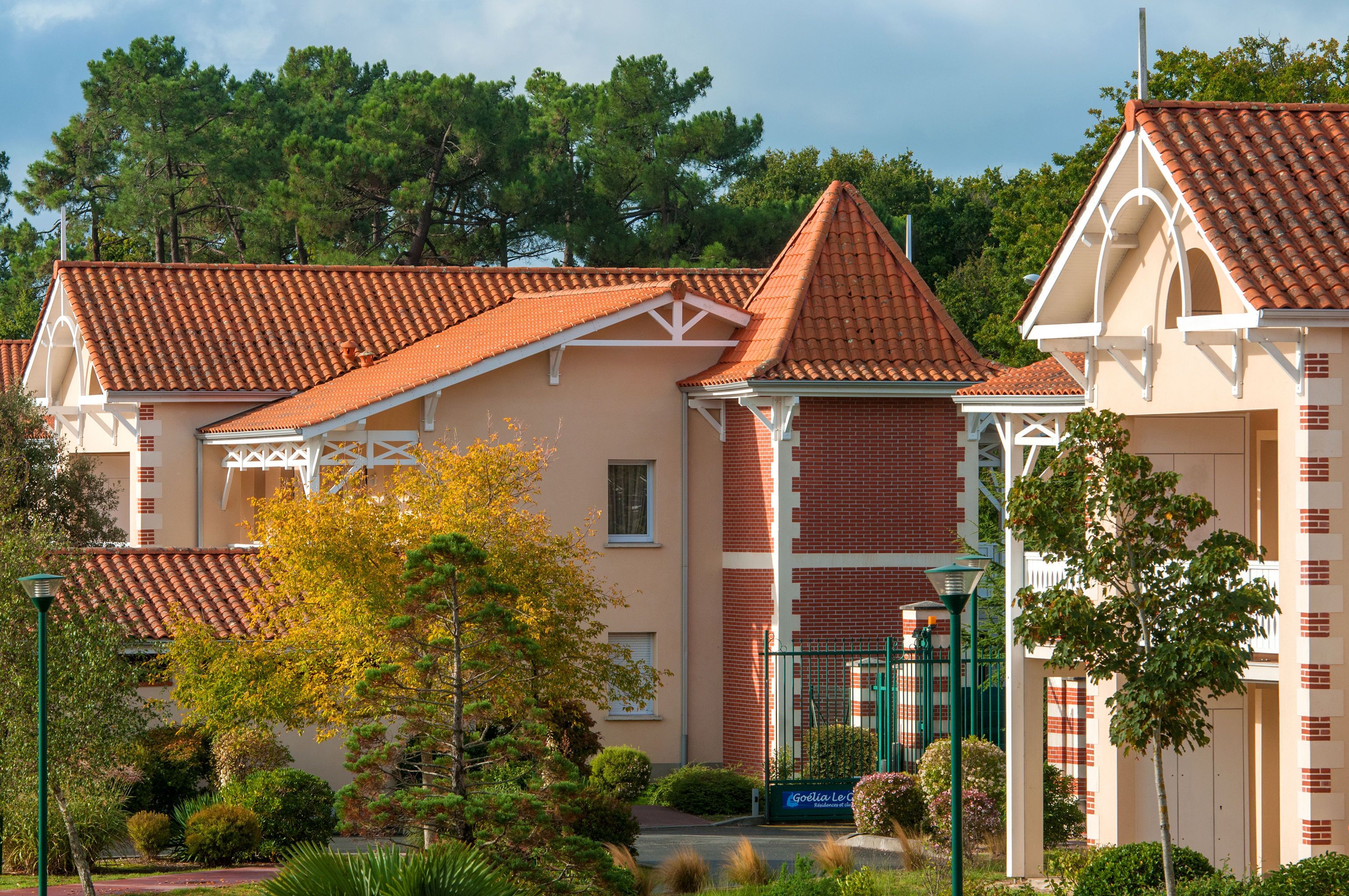 A building with a red-tiled roof, brick walls, and white trim.