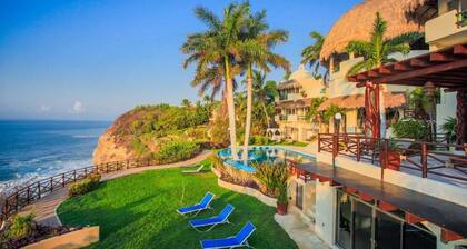 An exclusive beach house, perched on a cliff with panoramic ocean views.