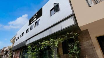 A modern building with a sign that reads 'Collection & Commercial Spaces.'