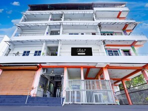 A multi-story building with a prominent sign reading 'Collection.' - Super Deluxe Room Ruthran Guest House (Tirukalukundram)