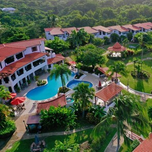 A resort with multiple buildings, a central swimming pool, and surrounding greenery. - Sunfish 1-bedroom ocean view apartment in Sand Street, Speightstown Apt 2 (Speightstown)