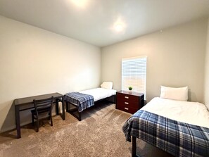 A bedroom with two beds, a desk, and a chair. - Brigham's Mill Retreat Between Grand Teton & Yellowstone National Parks (Rexburg)