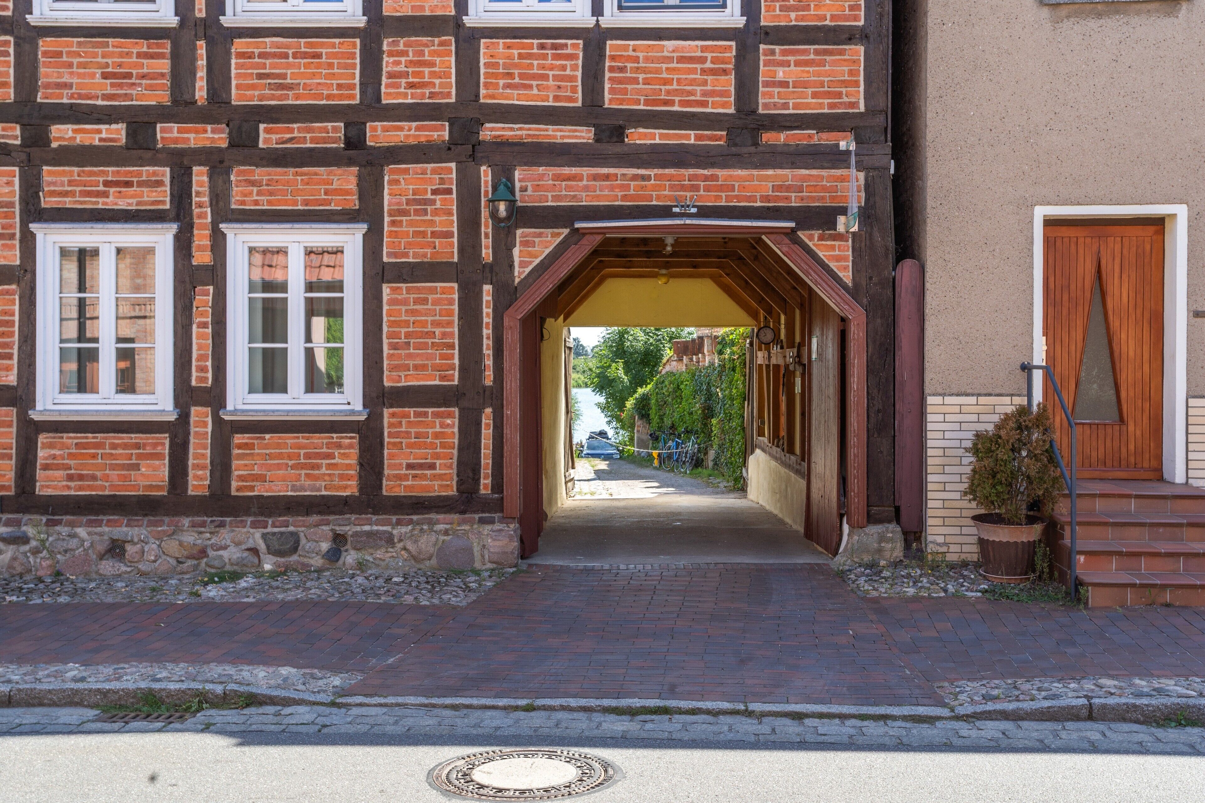 Un bâtiment traditionnel à colombages, doté d’un porche et d’une porte en bois.