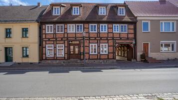 A row of traditional half-timbered houses with a street in front.