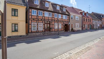 A row of traditional European-style buildings with a cobblestone street.