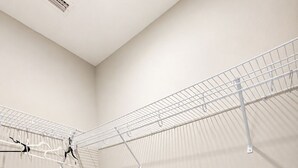 A laundry room with metal drying racks and a wooden floor. - Stay Anchored at 30a (Watersound)