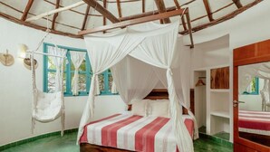 A room with a bed under a canopy, a hanging chair, a window with curtains, and a mirror. - Advanced Studies (Tulum)