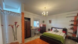 A bedroom with a bed, a desk, a chair, a dresser, and a bookshelf. - COMFORT AND PEACE OF MIND (Remire-Montjoly)