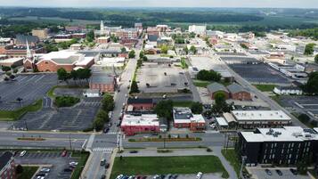 An aerial view of a town with a central square, buildings, and roads.