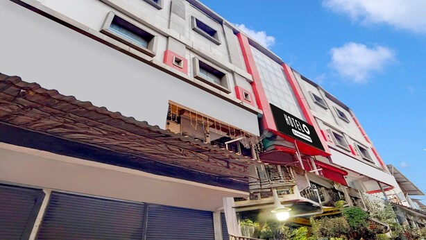 A multi-story hotel with a modern architectural design, featuring a prominent 'HOTEL' sign, multiple windows, and a balcony area. - Premium Kunnamangalam Near Bus Stand (Kozhikode)
