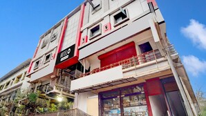 A multi-story hotel with a prominent 'HOTEL' sign, balconies, and a visible ground floor entrance. - Premium Kunnamangalam Near Bus Stand (Kozhikode)