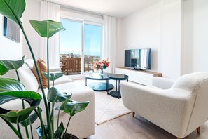 A modern living room with a sofa, a coffee table, and a TV. - Jg35d - Modern 2br Apartment With Terrace (Marbella)