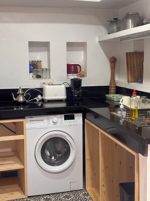 A compact kitchen with a washing machine, a toaster, and a coffee maker. - Tremendous 3-Private bedroom  riad in Marrakech perfect for your getaway (Marrakech)