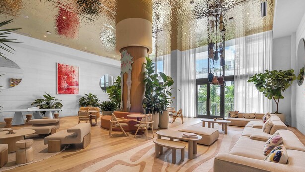 A spacious living area with modern furniture, large windows, and indoor plants. - Monthly Stay Studio · Midtown Miami, Free Parking (Miami)