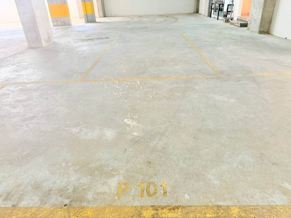 A parking area with concrete flooring and yellow parking lines, labeled 'P 101'.