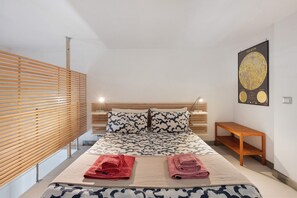 A modern bedroom with a bed, wooden headboard, and a wall-mounted poster. - Vacation Home 'The Pepper in Pizzofalcone' with Balcony, Wi-Fi & Air Conditioning (Naples)