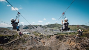 A person on a zip line over a rugged landscape with mountains in the background. - 5 Bed in Bala (oc-bow163) (Bala)