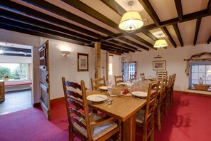 A dining room with a wooden table set for four, surrounded by wooden chairs. - 5 Bed in Grasmere (oc-gl008) (Grasmere)