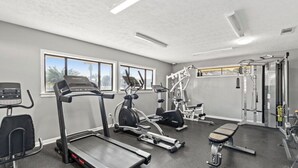 A gym with treadmills, elliptical machines, a bench, and weightlifting equipment. - 4 bed 2 bath townhome walking distance from the beach! (Panama City Beach)