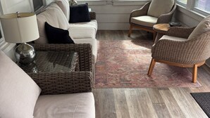 A living room with a sofa, two armchairs, a coffee table, and a rug. - 5 bedroom house one block to Sea Girt beach (Sea Girt)