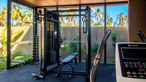 A gym with exercise equipment, a bench, and a control panel. - Azuk Milagres 6 p Close to Patacho Beach by MME (Porto de Pedras)