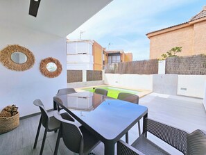 A patio with a table and chairs, a small pool, and a view of neighboring buildings. - Sweet Home Cabo de Palos by Interhome (Cabo de Palos)