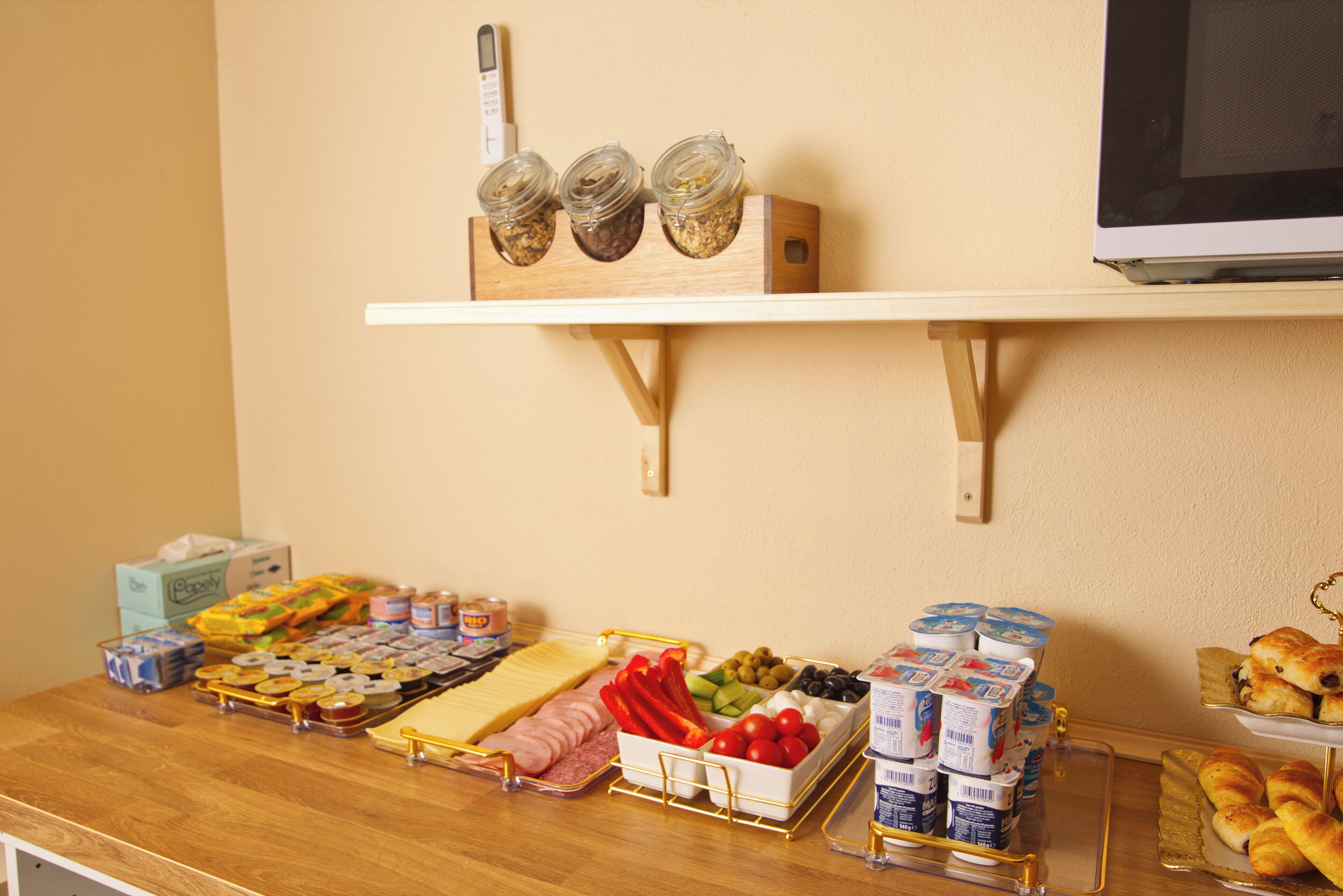 A buffet table with various food items and condiments.