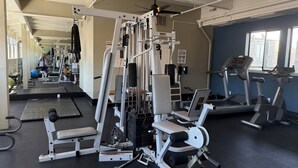 A gym with exercise equipment, treadmills, and a ceiling fan. - Oceanfront 2/2 Condo w/ Panoramic Views on Del Monte Beach (Monterey)