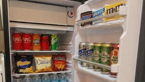 A refrigerator stocked with various beverages and snacks. - Soothing studio with AC in lovely Olongapo City (Olongapo City)