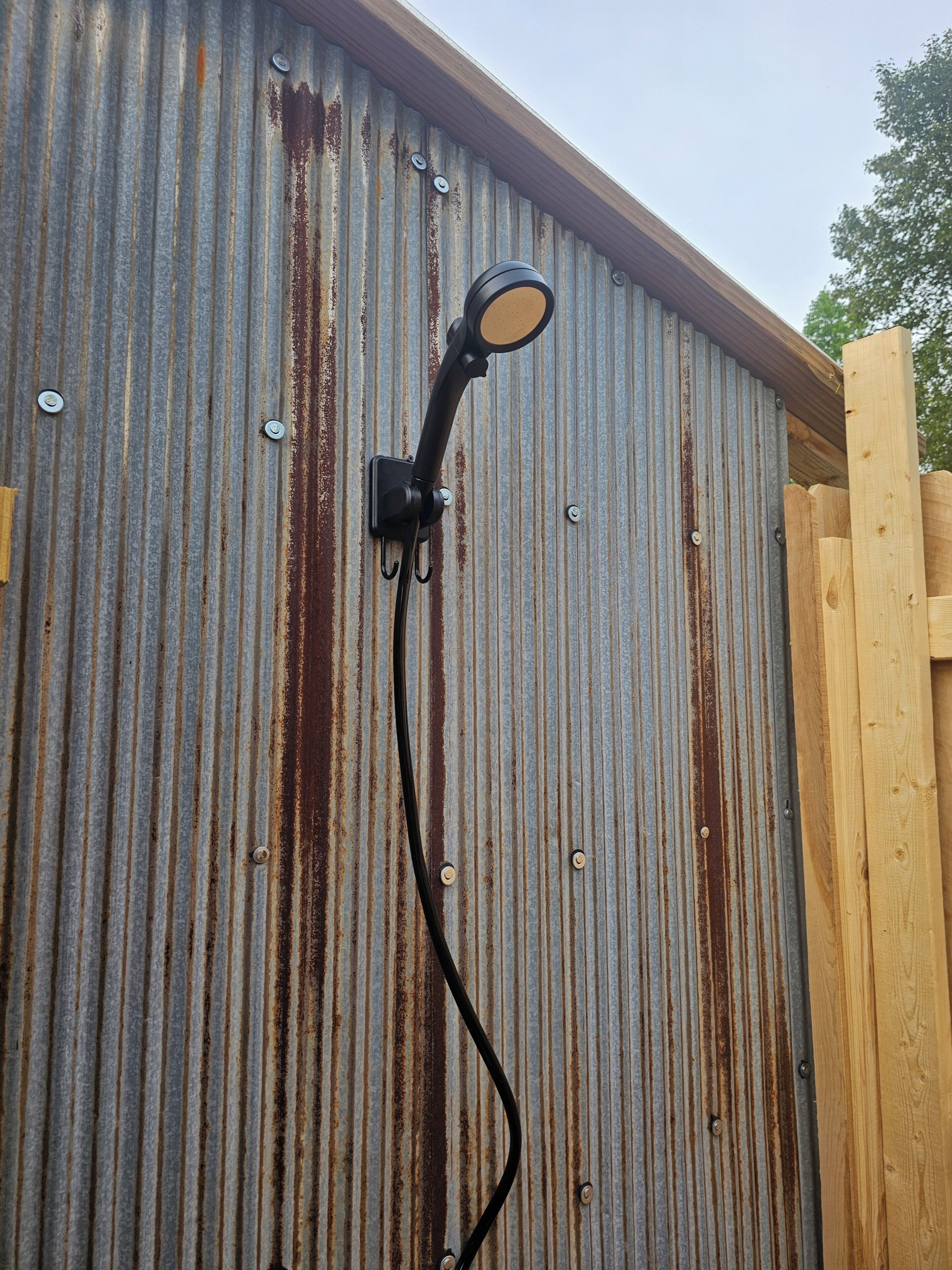 A metal wall with a mounted outdoor light fixture.