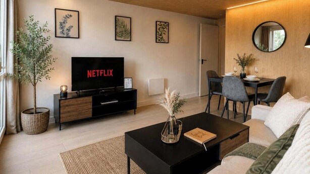 A modern living room with a flat-screen TV, a dining area with chairs, a sofa, and a coffee table. - 2 BEDROOM 2.5 BATHROOM - MODERN - OLD TRAFFORD - CITY CENTRE (Manchester)