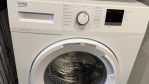 A front-loading washing machine with a control panel, a digital display, and a transparent door. - 2 BEDROOM 2.5 BATHROOM - MODERN - OLD TRAFFORD - CITY CENTRE (Manchester)