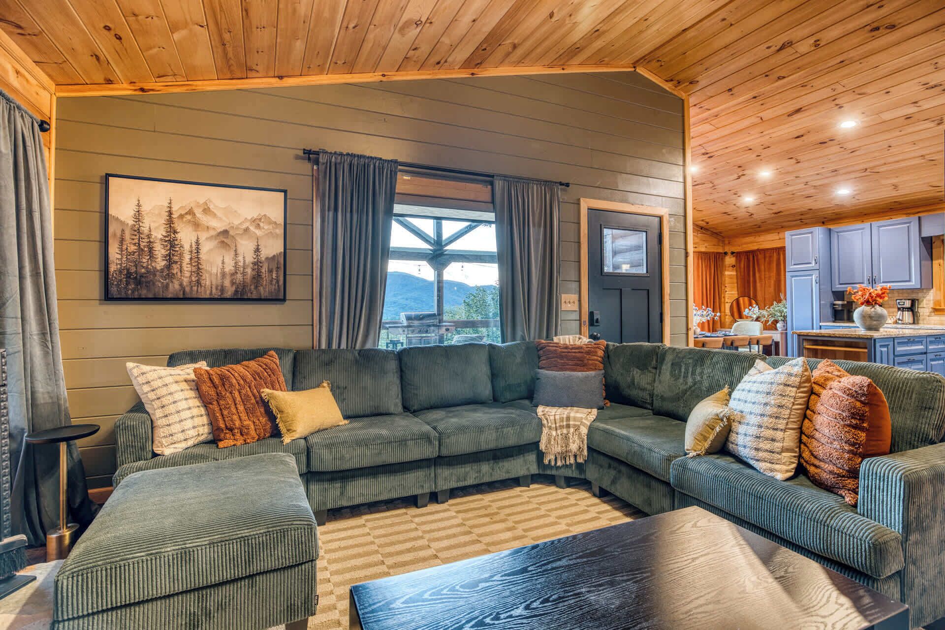 A cozy living room with a sectional sofa, a coffee table, and a painting on the wall.