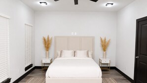 A bedroom with a bed, two bedside tables, a ceiling fan, and a door. - Modern Houston Retreat: Free Parking, Group Friendly, Near Med Center & Downtown (Houston)