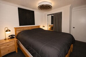 A bedroom with a bed, bedside lamps, a telephone, a wall-mounted artwork, and a door. - ML 290: Mountain Bliss at Snowshoe | Summer Trails & Breathtaking Views (Snowshoe)
