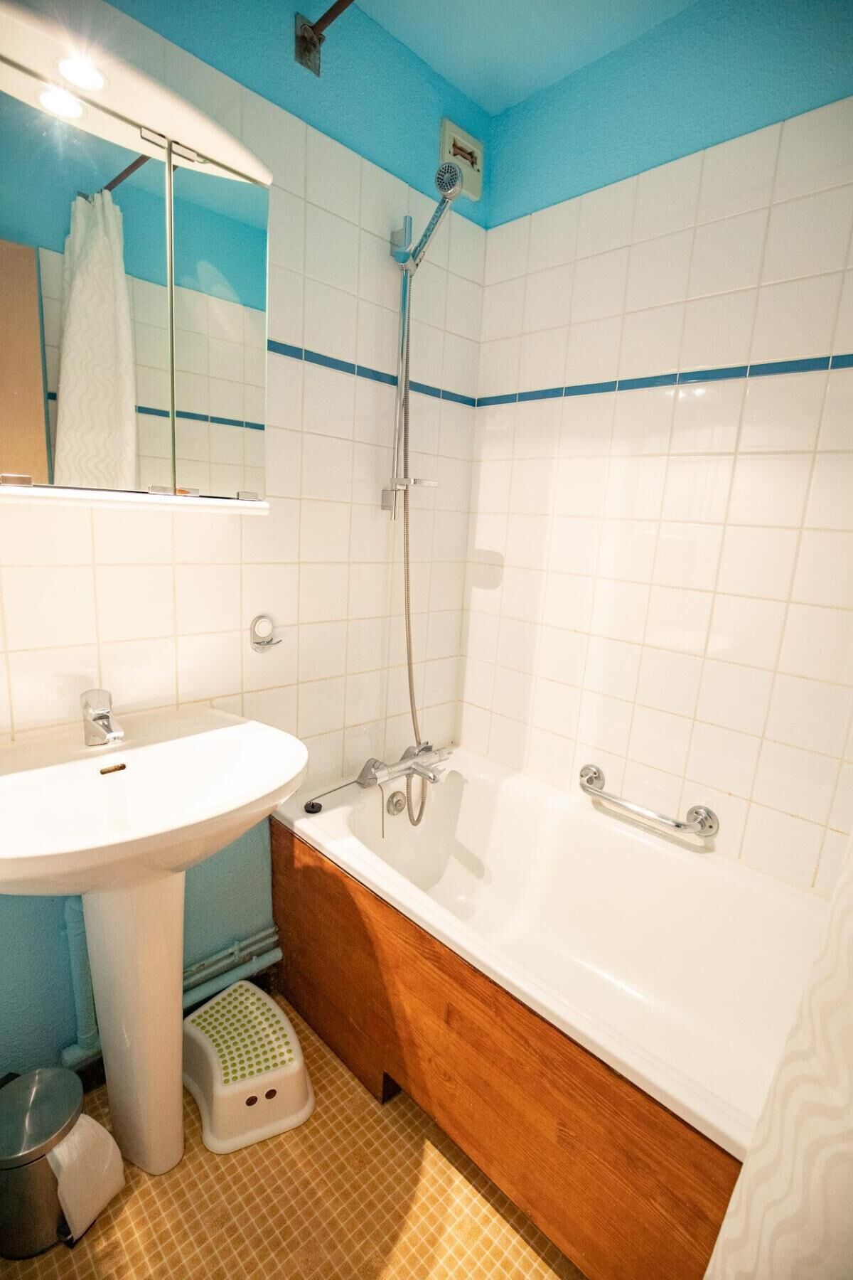 A bathroom with a white sink, a bathtub, and a shower.