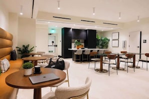 A modern hotel lobby with a seating area, a bar, and a kitchenette. - Prime Miami Luxury Unit | King Bed | Sleeps 2  |  Free Parking (Miami)