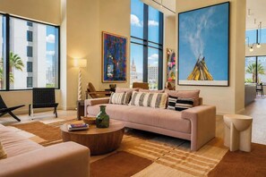 A modern hotel lobby with a large window, a sofa, a coffee table, and artwork on the walls. - Prime Miami Luxury Unit | King Bed | Sleeps 2  |  Free Parking (Miami)