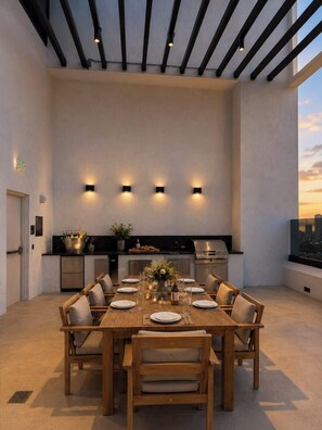 A modern dining area with a wooden table set for six, a kitchen with stainless steel appliances, and a cityscape view through a window. - Prime Miami Luxury Unit | King Bed | Sleeps 2 (Miami)