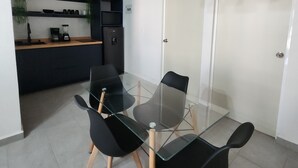 A modern kitchen with a glass dining table, black chairs, and pendant lights. - Perfect 2-bedroom apartment with AC in lovely Acapulco de Juárez (Acapulco de Juárez)