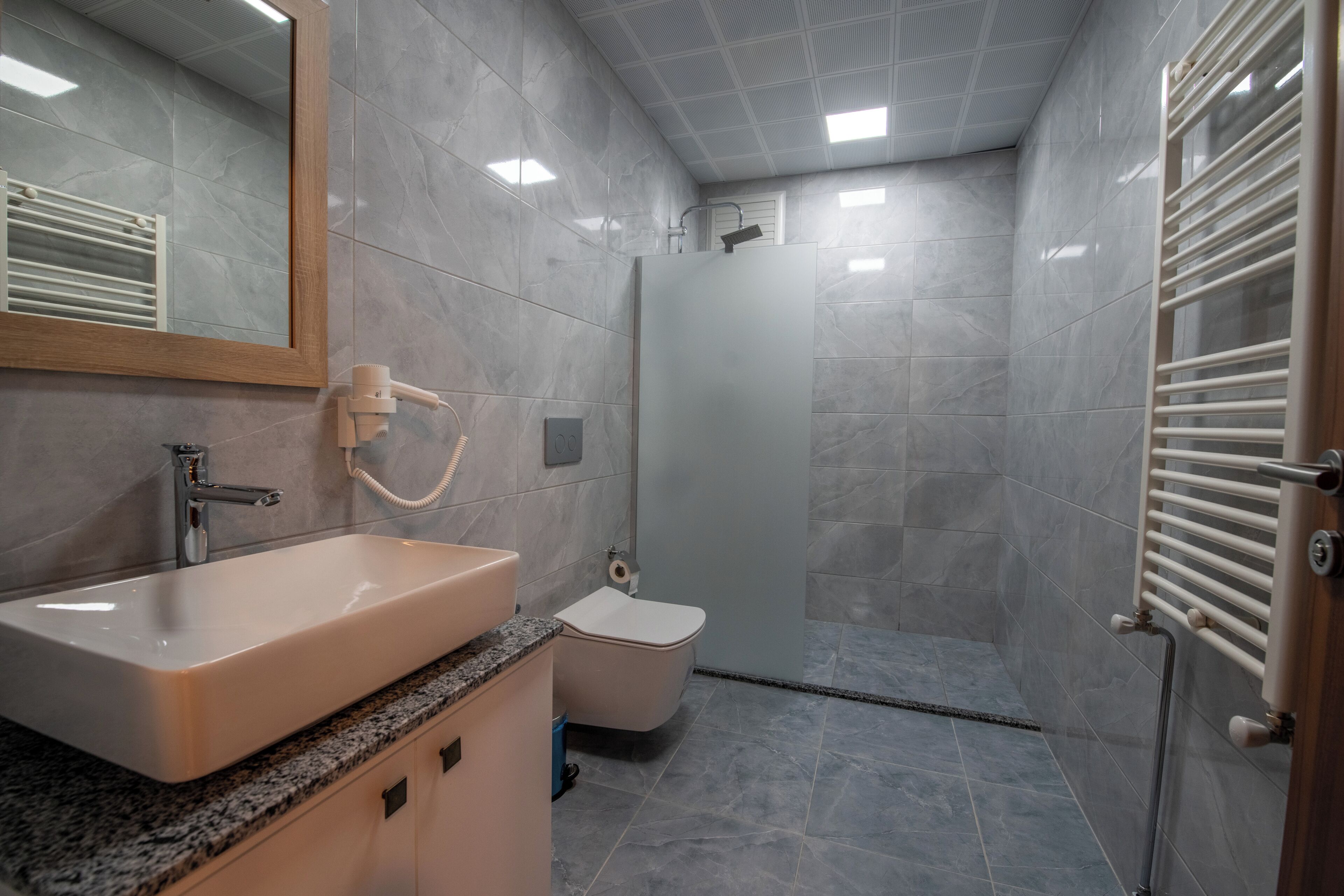 A bathroom with a sink, toilet, and shower.