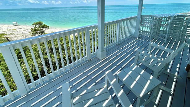 A covered outdoor area with a view of a beach and ocean. - Beachfront Secluded Sunset Sanctuary with Panoramic Views (Captiva)