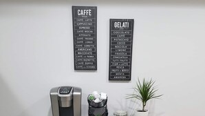 A kitchenette with a coffee machine, a trash bin, a small plant, and a shelf with mugs. - Private DC Apartment - 1BR - Walk to Metro - Explore Washington DC (Washington)