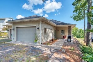 A single-story house with a garage, a front porch with a chair, and a mailbox. - Hilltop Escape - Enjoy Lake Superior Views with City Amenities (Bayfield)